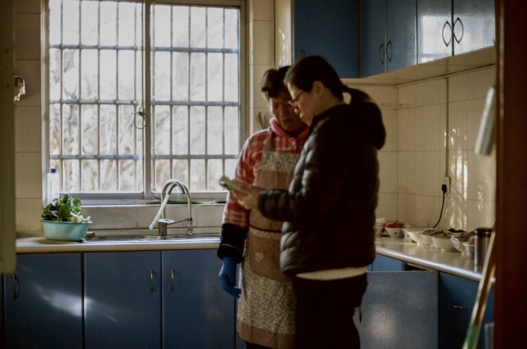 Elderly couple together in a warm home kitchen