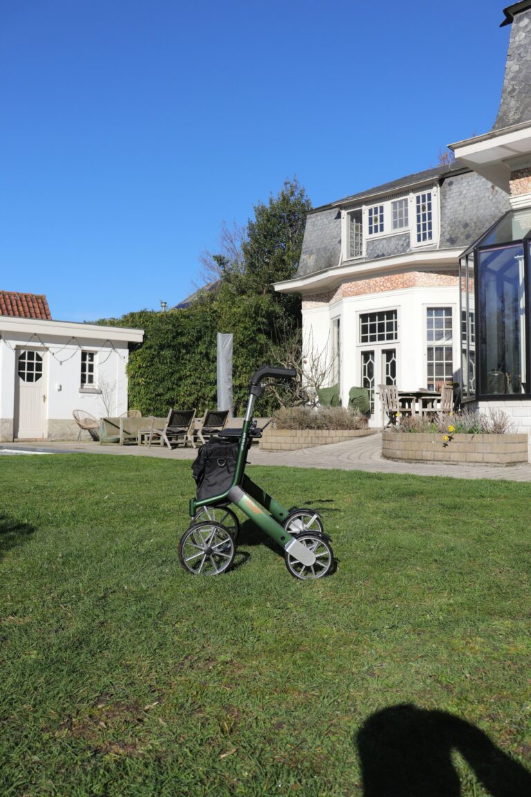 Senior using a walker outdoors on a sunny path