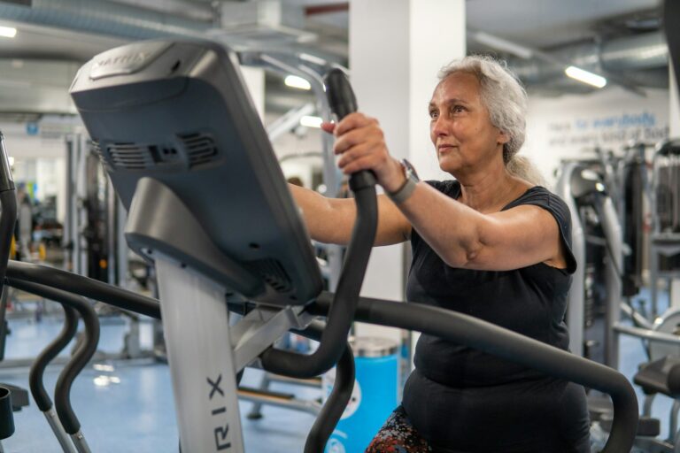 Older woman performing a leg workout in a gym